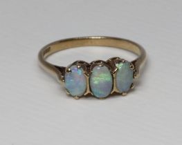 A hallmarked 9ct gold three stone opal ring, gross weight 1.9g, size M. Condition good, general wear