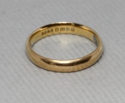 A hallmarked 22ct gold wedding band, weight b3.2g, size J. Condition - slightly oval in shape,