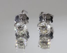 A pair of diamond ear studs, each round brilliant cut stone weighing approx. 0.50cts, screw back