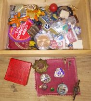 A wooden box of badges and pins including military, silver etc.