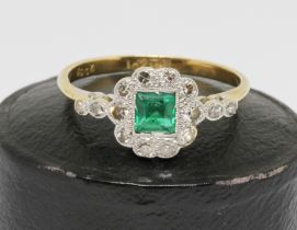 An Art Deco emerald and diamond ring, the central rectangular emerald measuring approx. 4.2mm x 3.