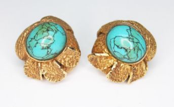 A pair of turquoise earrings, each of flower form set with a turquoise cabochon and surrounded by