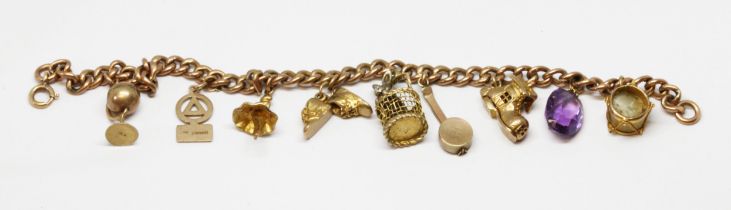 A 9ct gold charm bracelet, three hallmarked 9ct gold charms, four marked '9ct' and one unmarked,