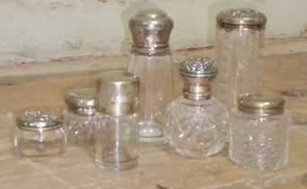 A collection of hallmarked silver topped glass ware.