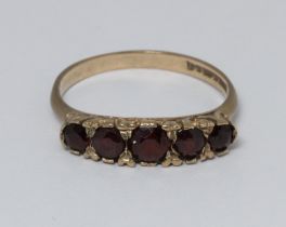 A hallmarked 9ct gold five stone garnet ring, gross weight 2.6g, size P.