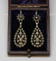 A pair of Georgian diamond earrings, each formed as a central scroll drop set with single diamond