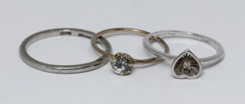 Three rings; a band marked 'Platinum' weight 3g, a single stone diamond ring unmarked weight 1g