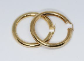 A pair of large tubular hoop earrings, 9ct gold international convention marks, diameter 50mm,