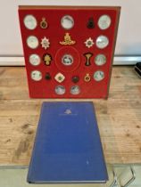 A Birmingham Mint 'Queen`s Guards collection of medals and badges', mounted on a display board....