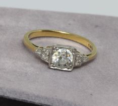 An Art Deco style diamond ring, the central stone weighing approx. 0.50cts, three melee diamonds