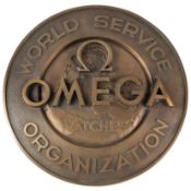 A BRONZE OMEGA WORLD SERVICE ORGANISATION PLAQUE CIRCA 1960s Diameter approx. 29cm. In excellent