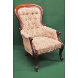 Victorian mahogany framed button back armchair having floral upholstery, standing on cabriole legs