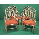 Set of four 20th century bamboo armchairs having arched backs over removable seat cushions, standing