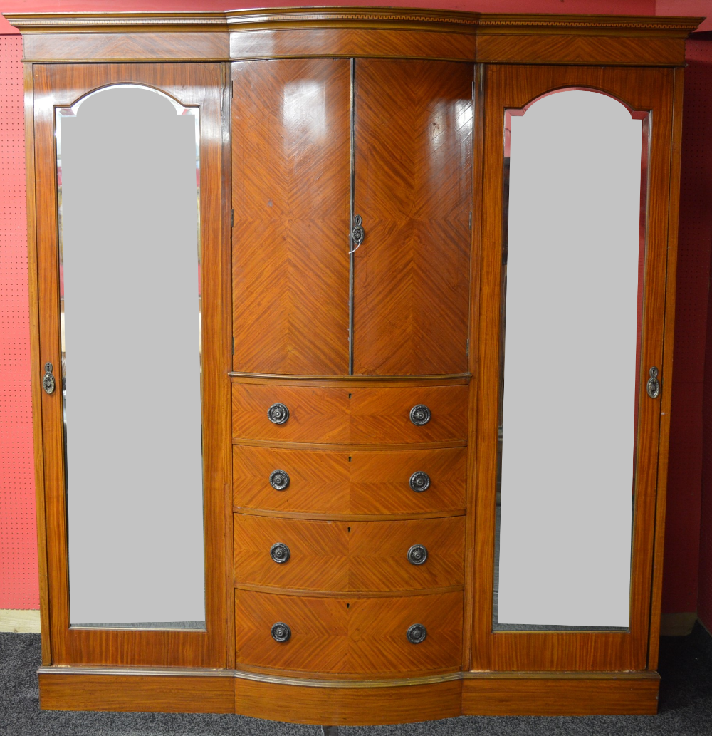 Late 19th century mahogany wardrobe having bow front centre section of two doors over four graduated