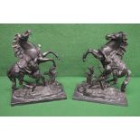 Pair of black painted spelter figures of rearing horses and handlers, standing on rectangular