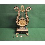 Ebonised lyre formed mantel clock having ormolu mounts and standing on ormolu scrolled feet, the