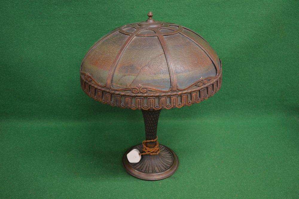 Bronzed table lamp the shade having sectional glass panels decorated with river, trees and