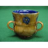 Royal Doulton stoneware TYG having three handles and mottled glaze with blue flower head motif