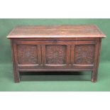 19th century oak coffer having three carved panel front, the top opening to reveal right hand candle