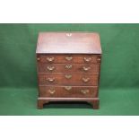 19th century oak bureau having fall front opening to reveal fitted interior of pigeon holes and