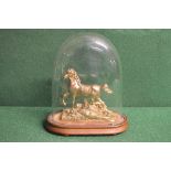 Gilt metal figure of a horse walking over rough ground, standing on an oval wooden base under