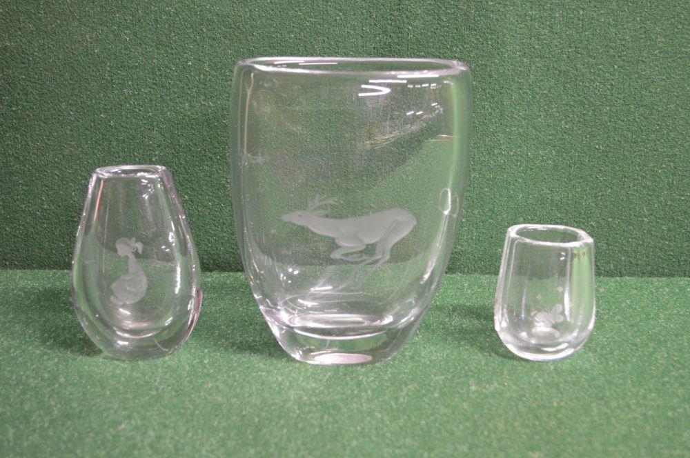 Two Kosta clear glass vases having engraved decoration - 4.75" and 7.5" tall together with one other