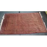 Red ground rug having black and cream pattern with end tassels, purchased in Afghanistan - 2.17m x