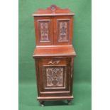 Mahogany coal purdonium the top having raised back over two carved panel doors, the lower section