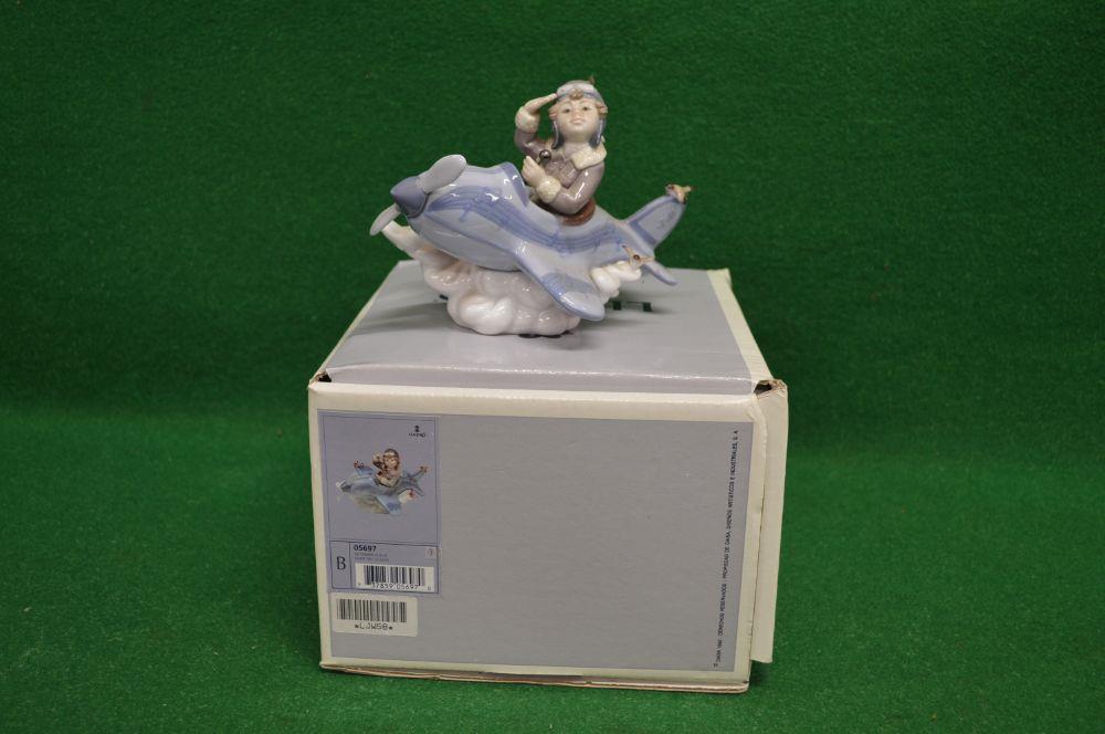 Lladro figure No. 5697 of a young boy flying an aeroplane, with original box - 5.5" tall Please note