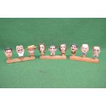 Group of nine carved wooden painted bottle toppers having cork bottoms Please note descriptions
