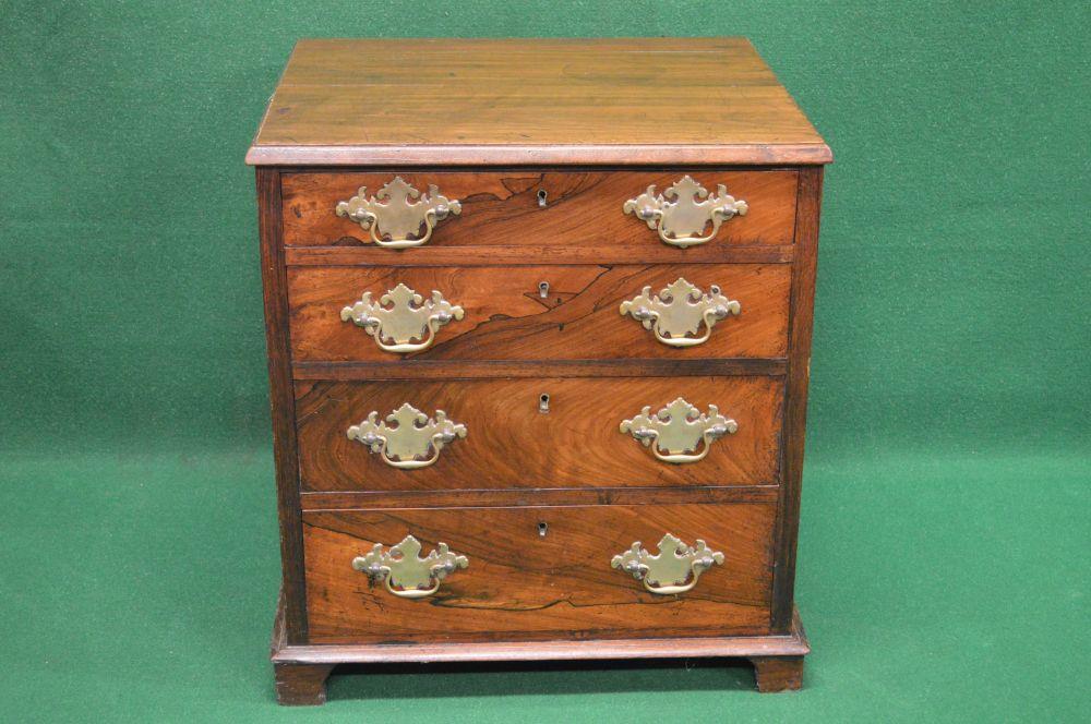 19th century mahogany and rosewood chest of drawers, the top having moulded edge over four short