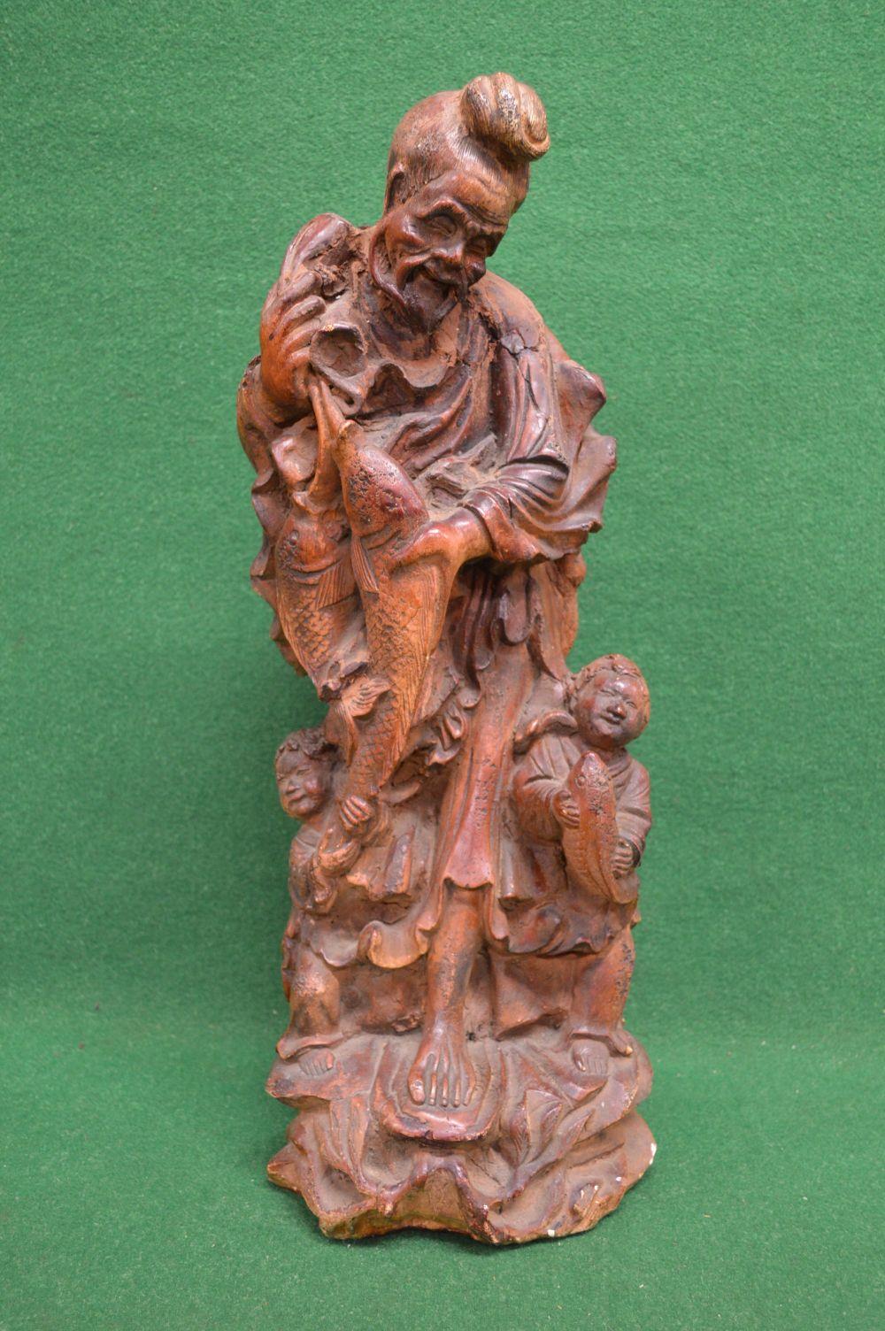 Painted chalk figure of Oriental man and two young boys holding a carp - 22.5" tall Please note