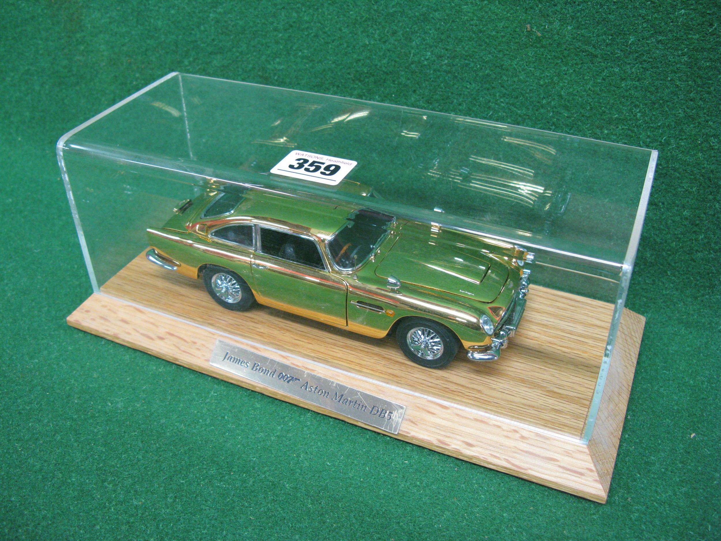 Danbury Mint diecast and plastic model of James Bond's Aston Martin DB5 in gold with many moving