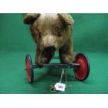 80 year old possibly Chad Valley wheeled bear with solid wheels and steering, well loved but now