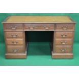 Walnut pedestal desk having tan leather insert with gilt toolwork border over single row of three