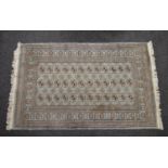 Pale blue ground rug having white, black and orange pattern with end tassels - 2.02m x 1.23m