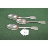 Set of three silver dessert spoons having Fiddle pattern handles with crest engraving, hallmarked