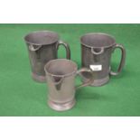Pair of pewter quart tankards with side spouts together with a one pint tankard with side spout