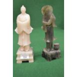 Possibly green jade figure of an Oriental fisherman - 9.5" tall together with one other of an