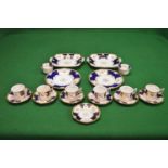 Coalport tea set having floral and gilt pattern on a white ground with blue and gilt border to