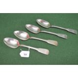 Set of four heavy gauge Irish silver table spoons having Fiddle pattern handles with crest