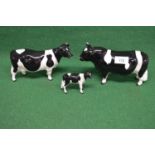 Three Beswick figures of a Frisian bull, cow and calf Please note descriptions are not condition