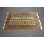 Beige ground rug having red, black and cream pattern with end tassels - 1.99m x 1.29m Please note