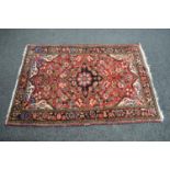 Red ground rug having red, blue, gold and cream pattern - 1.58m x 1.06m Please note descriptions are