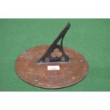 Bronze circular sundial with pierced gnomon inscribed around the edge and dated 1705, with two