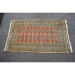 Beige ground rug with red, black and white pattern with end tassels - 1.71m x 0.99m Please note