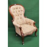 Victorian mahogany framed button back armchair having floral upholstery, standing on cabriole legs