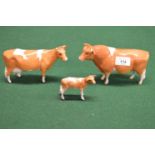 Three Beswick figures of Guernsey bull, cow and calf Please note descriptions are not condition