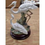 Lladro figure of two Herons No. 5691 standing on a circular wooden base - 13.25" tall Please note