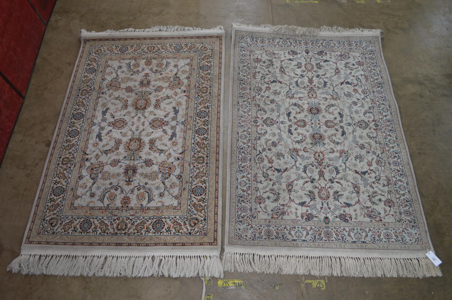 Two cream ground rugs with end tassels - 67" x 39.5" Please note descriptions are not condition